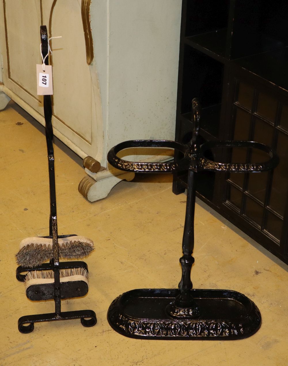 A painted cast iron stick stand, H.60cm together with a boot brush stand